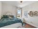 Bright bedroom with a detailed headboard, cozy bedding, a decorative side table, and stylish window treatments at 141 Sandy Bend Ln, Summerville, SC 29486
