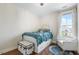 Inviting bedroom with a detailed bed frame, cozy armchair, and natural light, creating a peaceful retreat at 141 Sandy Bend Ln, Summerville, SC 29486