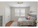 Comfortable bedroom featuring a bed with stylish bedding, closet, and natural light from the windows at 141 Sandy Bend Ln, Summerville, SC 29486