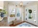Inviting entryway featuring natural light, woven benches, and stylish light fixture at 141 Sandy Bend Ln, Summerville, SC 29486