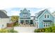 Charming home with a spacious front porch, inviting entrance, detached two-car garage and lush landscaping at 141 Sandy Bend Ln, Summerville, SC 29486