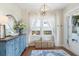 Bright and airy foyer with stylish decor, a blue cabinet, and a view of the exterior through the window at 141 Sandy Bend Ln, Summerville, SC 29486