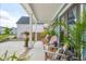 Inviting front porch with comfortable wooden chairs, plants, and lush landscaping, perfect for relaxing at 141 Sandy Bend Ln, Summerville, SC 29486
