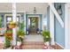 Inviting front porch features lush plants, an inviting entrance, and comfortable seating for outdoor enjoyment at 141 Sandy Bend Ln, Summerville, SC 29486