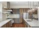 An open kitchen features stainless steel appliances, ample counter space, and a central island with modern pendant lighting at 141 Sandy Bend Ln, Summerville, SC 29486