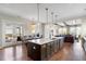 Open kitchen and dining area with a large center island and modern lighting at 141 Sandy Bend Ln, Summerville, SC 29486