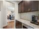A kitchen space includes custom cabinetry and marble countertops with a view through an open doorway to the bedroom at 141 Sandy Bend Ln, Summerville, SC 29486