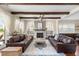 Spacious living room with beamed ceilings, fireplace, and comfortable leather couches at 141 Sandy Bend Ln, Summerville, SC 29486