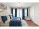 A luxurious main bedroom with an upholstered headboard, high ceilings, and elegant window treatments at 141 Sandy Bend Ln, Summerville, SC 29486