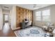Bright office featuring a decorative wood accent wall, modern desk, and stylish rug for a comfortable workspace at 141 Sandy Bend Ln, Summerville, SC 29486