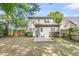 Backyard with small patio, green shrubs, and rear view of the two-story house at 1429 Swamp Fox Ln, Charleston, SC 29412