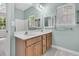 Bright bathroom featuring double sinks, a window overlooking the exterior, and wood cabinets at 1429 Swamp Fox Ln, Charleston, SC 29412