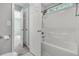 Bright bathroom features a shower over tub with white tile and a window for natural light at 1429 Swamp Fox Ln, Charleston, SC 29412