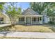 Charming single-Gathering home with a welcoming front porch, green front door, and a well-maintained lawn at 1429 Swamp Fox Ln, Charleston, SC 29412