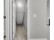 Hallway with light gray walls and wood flooring, and a door leading to a storage space at 1429 Swamp Fox Ln, Charleston, SC 29412
