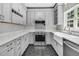 Bright kitchen with stainless steel appliances, quartz countertops, and gray cabinets at 1429 Swamp Fox Ln, Charleston, SC 29412