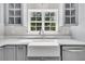 Close up on bright kitchen, with a large sink, quartz countertop and view to the outside at 1429 Swamp Fox Ln, Charleston, SC 29412