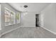 Spacious living room with light colored new floors, and three windows at 1429 Swamp Fox Ln, Charleston, SC 29412