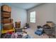 A cluttered bedroom with neutral walls, a small window, and basic carpet flooring at 143 West Bradford Pointe Dr, Summerville, SC 29486