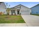 Attractive single-Gathering home with a manicured lawn, garage, and welcoming curb appeal at 143 West Bradford Pointe Dr, Summerville, SC 29486