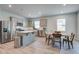 Bright, open kitchen featuring an island, stainless appliances, and a dining area at 143 West Bradford Pointe Dr, Summerville, SC 29486