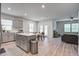 Open-concept kitchen and dining area with wood floors, stainless appliances, and an island at 143 West Bradford Pointe Dr, Summerville, SC 29486