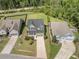 Aerial perspective of a well-maintained home with a green lawn, long driveway, and neighboring properties at 1489 Brockenfelt Dr, Charleston, SC 29414