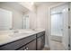 Bright bathroom featuring double sinks with a large mirror and a view into the shower/tub at 1489 Brockenfelt Dr, Charleston, SC 29414