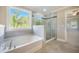 A primary bathroom featuring a soaking tub and a separate glass enclosed shower with a view at 1489 Brockenfelt Dr, Charleston, SC 29414