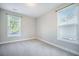 Cozy bedroom with neutral carpet, two windows, and natural light at 1489 Brockenfelt Dr, Charleston, SC 29414