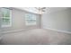 A bright bedroom features two windows, light-colored walls, trim, and carpet with a ceiling fan at 1489 Brockenfelt Dr, Charleston, SC 29414