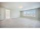 Expansive bonus room features neutral carpet, a doorway, and multiple windows at 1489 Brockenfelt Dr, Charleston, SC 29414