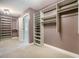 A closet with wood shelving and mauve-colored walls with an open doorway to the bathroom at 1489 Brockenfelt Dr, Charleston, SC 29414