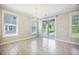 This dining room features tile flooring, two windows, and a sliding glass door with access to the porch at 1489 Brockenfelt Dr, Charleston, SC 29414