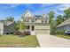 Charming two-story home features a covered front porch and a two-car garage at 1489 Brockenfelt Dr, Charleston, SC 29414