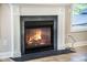 Cozy fireplace with a white mantle and black stone hearth, creating a warm and inviting atmosphere at 1489 Brockenfelt Dr, Charleston, SC 29414