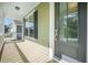 Covered porch entry featuring a decorative glass door and a view of the neighborhood at 1489 Brockenfelt Dr, Charleston, SC 29414