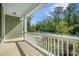 Inviting porch with white railings offers a scenic view of the surrounding greenery and neighborhood at 1489 Brockenfelt Dr, Charleston, SC 29414
