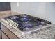 Stainless steel gas range cooktop with granite countertops and white tiled backsplash at 1489 Brockenfelt Dr, Charleston, SC 29414
