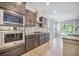 The kitchen features stainless steel appliances, granite countertops, tile backsplash, and access to the porch at 1489 Brockenfelt Dr, Charleston, SC 29414