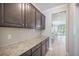 This kitchen features granite countertops, dark cabinets, and tile backsplash at 1489 Brockenfelt Dr, Charleston, SC 29414