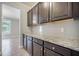 This kitchen features granite countertops, dark cabinets, and tile backsplash at 1489 Brockenfelt Dr, Charleston, SC 29414