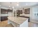 This kitchen island features granite countertops and pendant lighting at 1489 Brockenfelt Dr, Charleston, SC 29414