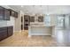 This kitchen features dark cabinets, granite countertops, an island, tile flooring, and stainless steel appliances at 1489 Brockenfelt Dr, Charleston, SC 29414
