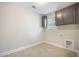 Functional laundry room with ample cabinet space above window and tile flooring at 1489 Brockenfelt Dr, Charleston, SC 29414