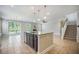 This living room features an island, access to a porch, a fireplace, and a staircase at 1489 Brockenfelt Dr, Charleston, SC 29414