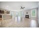 An open-concept living room flows to the kitchen, featuring a tile floor, fireplace, and natural light at 1489 Brockenfelt Dr, Charleston, SC 29414
