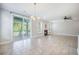 This living room features tile flooring, a fireplace, two windows, and a sliding glass door with porch access at 1489 Brockenfelt Dr, Charleston, SC 29414