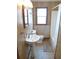 Bright bathroom featuring a pedestal sink, toilet, and shower at 1603 Lybrand St, Edisto Island, SC 29438