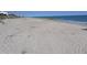 Beautiful sandy beach with gentle waves and a clear blue sky at 1603 Lybrand St, Edisto Island, SC 29438